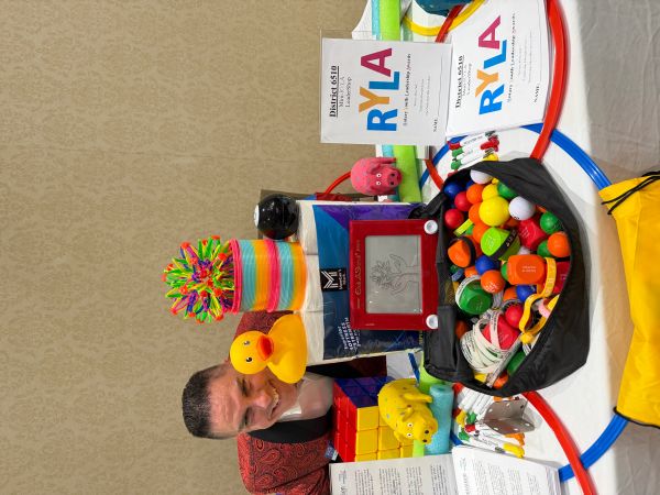 A colorful display of toys and educational materials at a Rotary Youth Leadership Awards event.