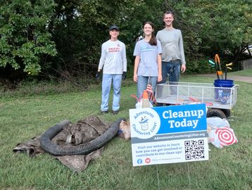 Group of people with trash collected during a litter cleanup