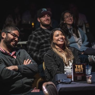 People enjoying a fun night of comedy at The Riot Comedy Club