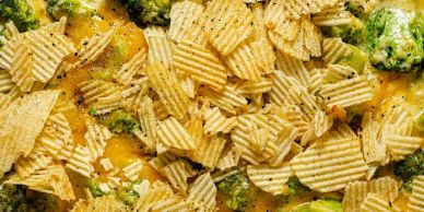 Close-up of cheesy broccoli casserole topped with ridged potato chips.