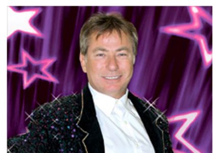 Smiling man in sparkly jacket.