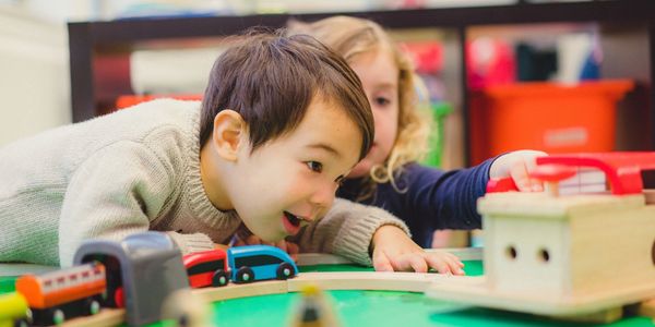 kids play with wooden train set