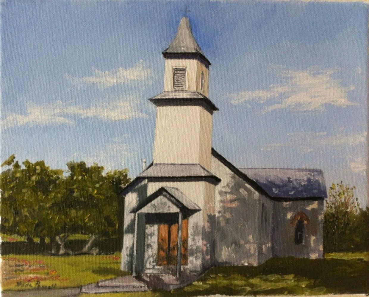 A small white church with a steeple under a clear blue sky.
