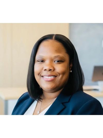 Professional woman smiling confidently in a business setting.