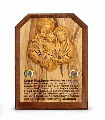 Wooden plaque featuring a carved Holy Family and the Lord's Prayer.
