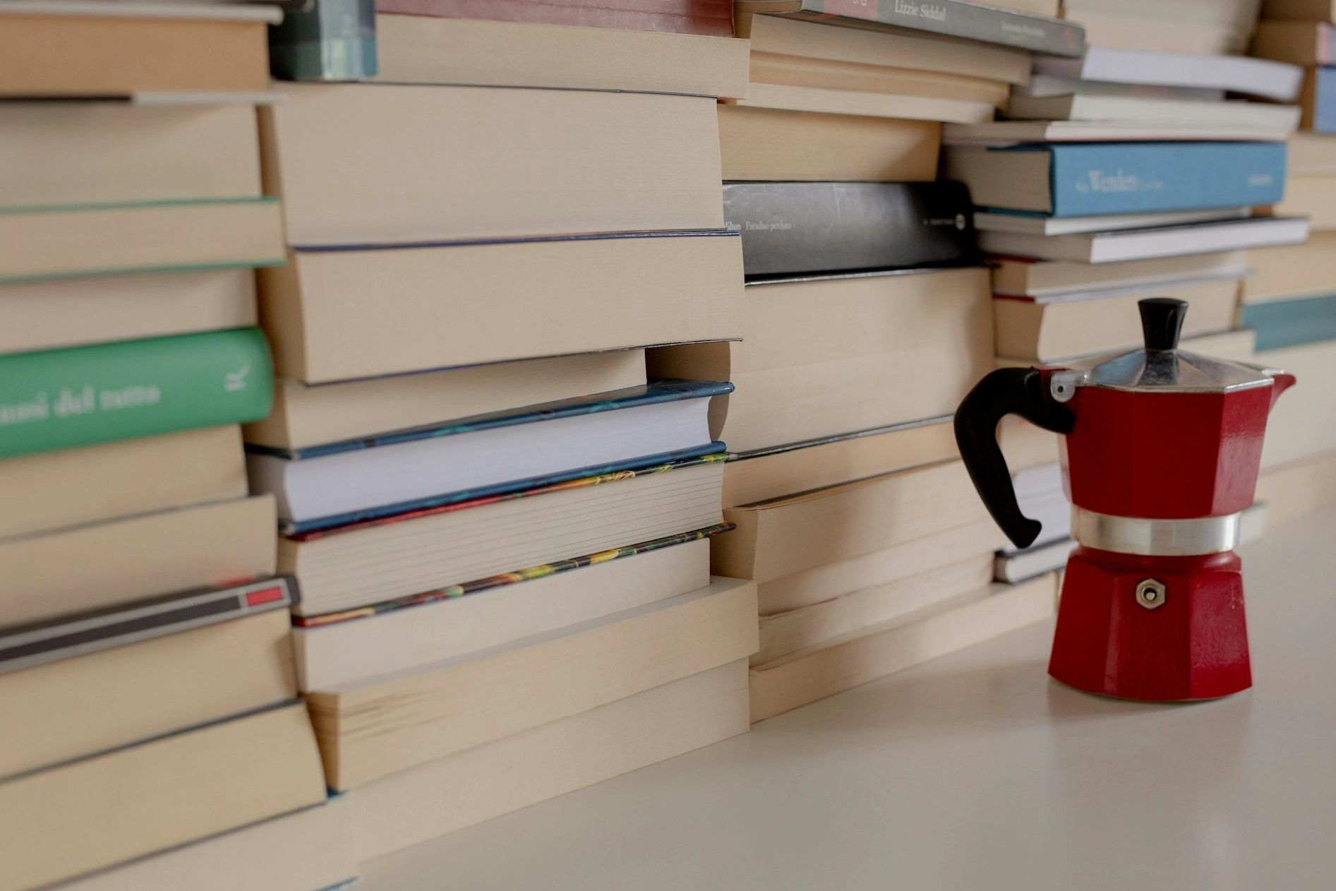 coffee pot with books on a shelf