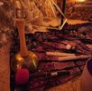 Traditional musical instruments and artifacts displayed on a woven mat.