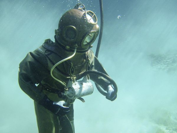 Diver in an old-fashioned deep-sea diving suit underwater.