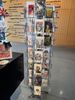 Display rack with assorted postcards and souvenirs in a store.