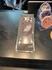 A transparent phone case with a skull design on a black surface.