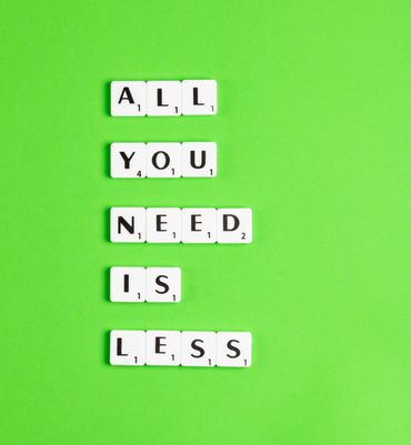 scrabble tiles which say all you need is less