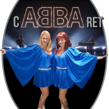 Two women dressed in blue ABBA-style costumes.