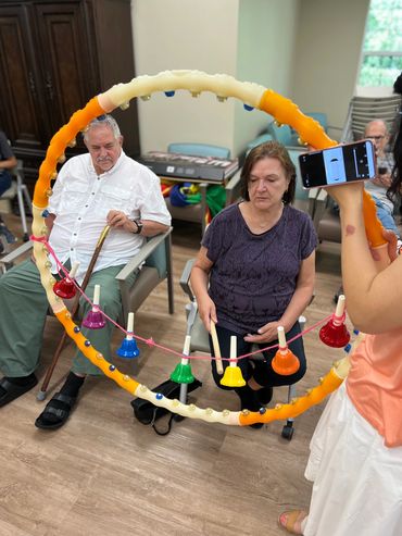 Peachtree Christian Health program participants playing the bells during a music therapy class.