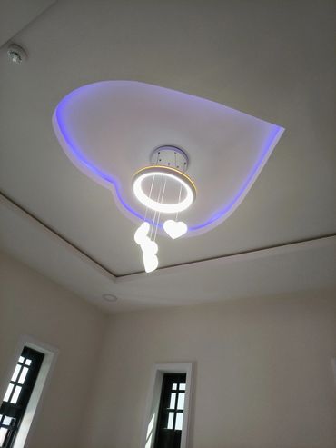 Modern ceiling light with heart-shaped pendants and purple LED accents.