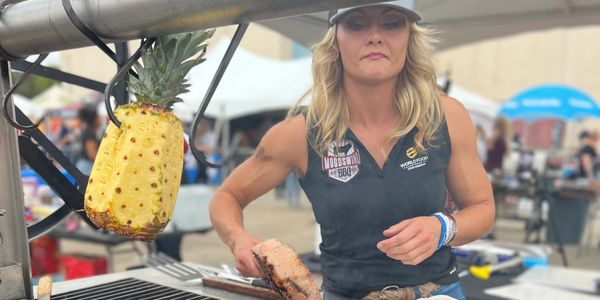 Woman grilling steaks