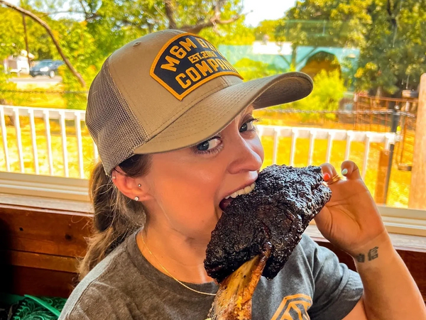 Woman eating a beef rib