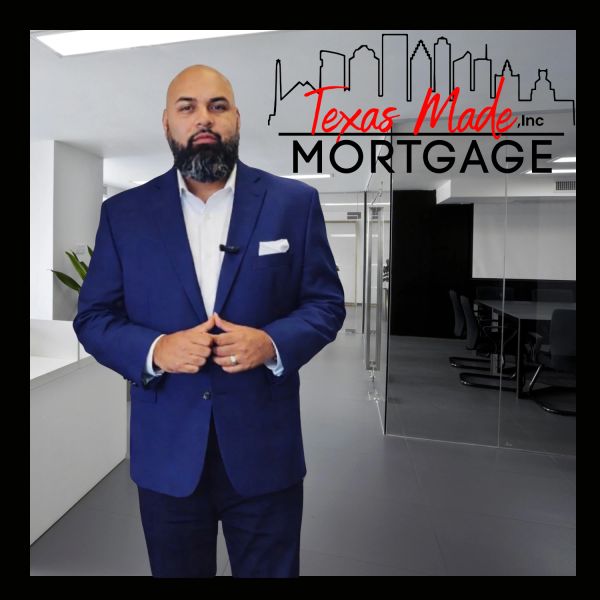 Professional man in blue suit standing in modern office for Texas Made Mortgage.