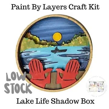 Layered craft kit showing lake scene with red gloves and a canoe.