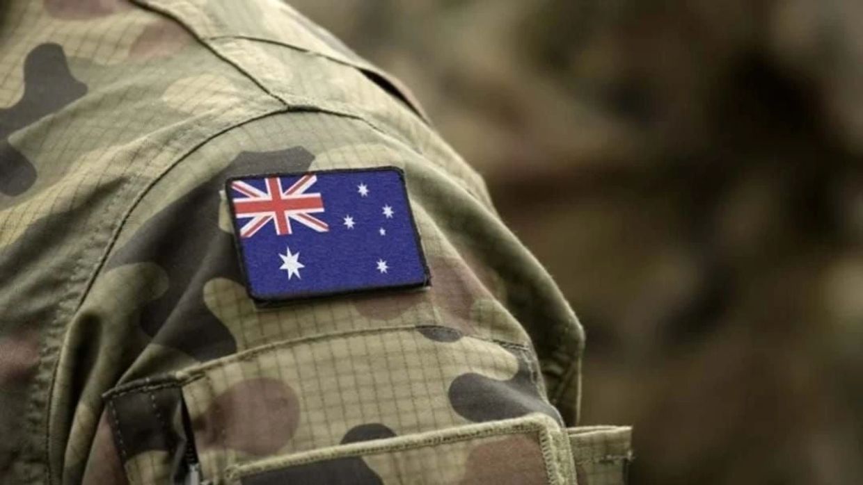 Australian flag patch on military camouflage uniform sleeve.