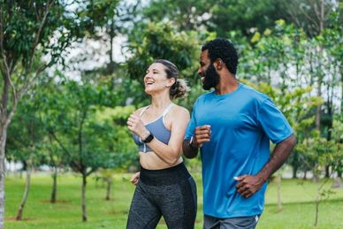 Couple jogging together outdoors.