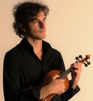 Man playing violin thoughtfully.