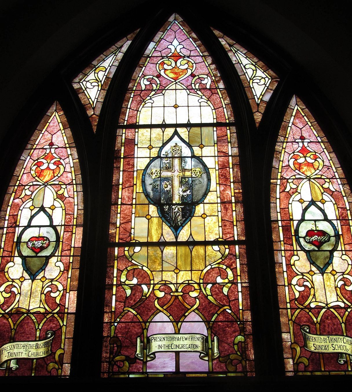 Intricately designed stained glass windows with religious symbols.