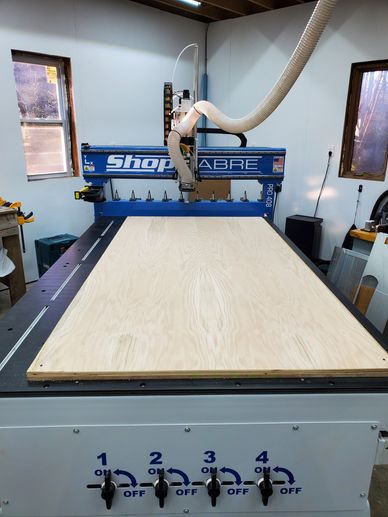 A ShopSabre CNC machine set up with a large wooden board ready for cutting.