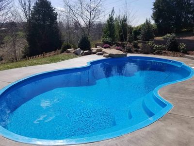 Modified kidney shaped pool and outdoor area