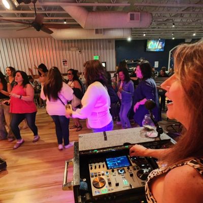 Crowd dancing during a wedding DJ set at the reception.