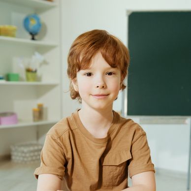 Child sitting at a table in counseling