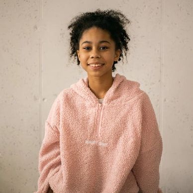 Teenager smiling after a psychotherapy session.