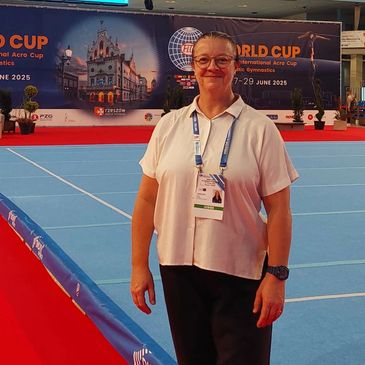 Woman standing on a blue gymnastics floor at the World Cup event.