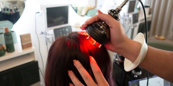 Red light therapy being applied to scalp at TT Head Spa in Arcadia and Long Beach, California
