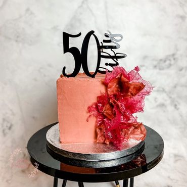 Square rust single tier 50th birthday cake with abstract wafer paper burst