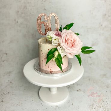 Pink ombré cake with fresh floral arrangement and 60 topper