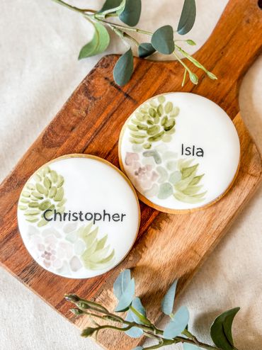 Hand painted iced biscuits with succulents and personalised names.