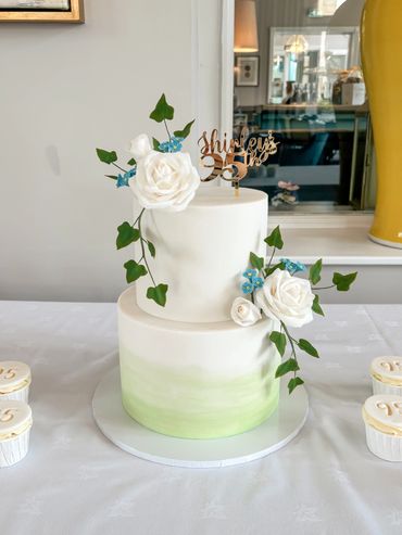 95th Two tier birthday cake with green ombré, sugar roses, forget me nots and ivy.