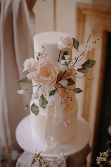 Close up of sugar flower display on a white 3 tier cake