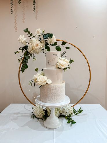 3 tier white wedding cake, with stencilled bottom tier, hand painted monogram and floral detail.