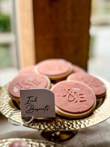 Rust coloured iced biscuits with embossed initials