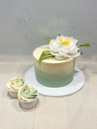 Sage green ombre cake with sugar peony and leaves. Plus matching ombre cupcakes.