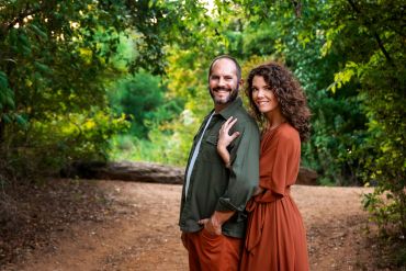 Couple smiling outdoors in autumn.