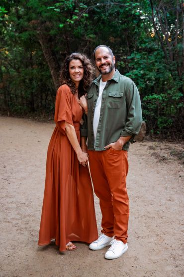 Couple smiling and posing in nature.