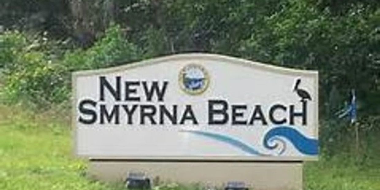 Welcome sign for New Smyrna Beach with nature elements.