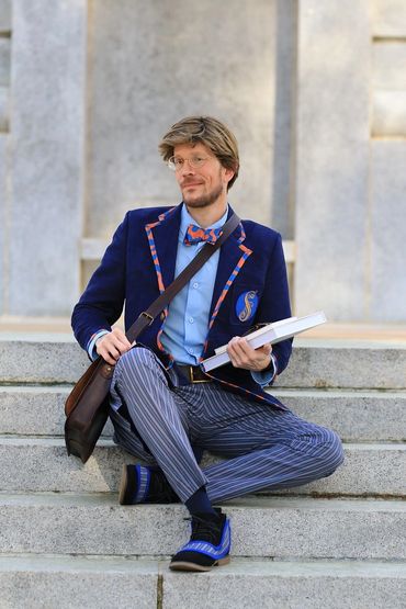 Shiz University uniform from Wicked. Outdoor cosplay photoshoot, hand crafted. Sitting on steps