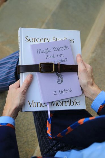 Shiz University uniform from Wicked. Outdoor cosplay photoshoot, hand crafted. Book prop closeup