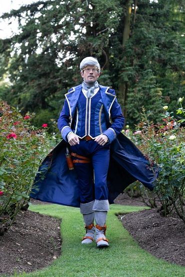 Percy de Rolo cosplay, striding through a rose garden, frockcoat billowing behind