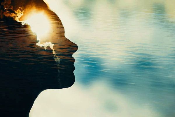 Woman silhouette with sun in head with copy space