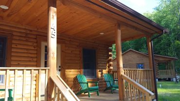 Exterior shot of two log cabins.