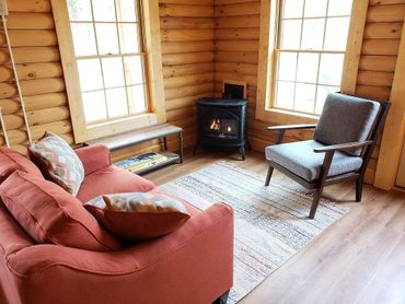 Living room featuring coffee table, gas fireplace, and chair.